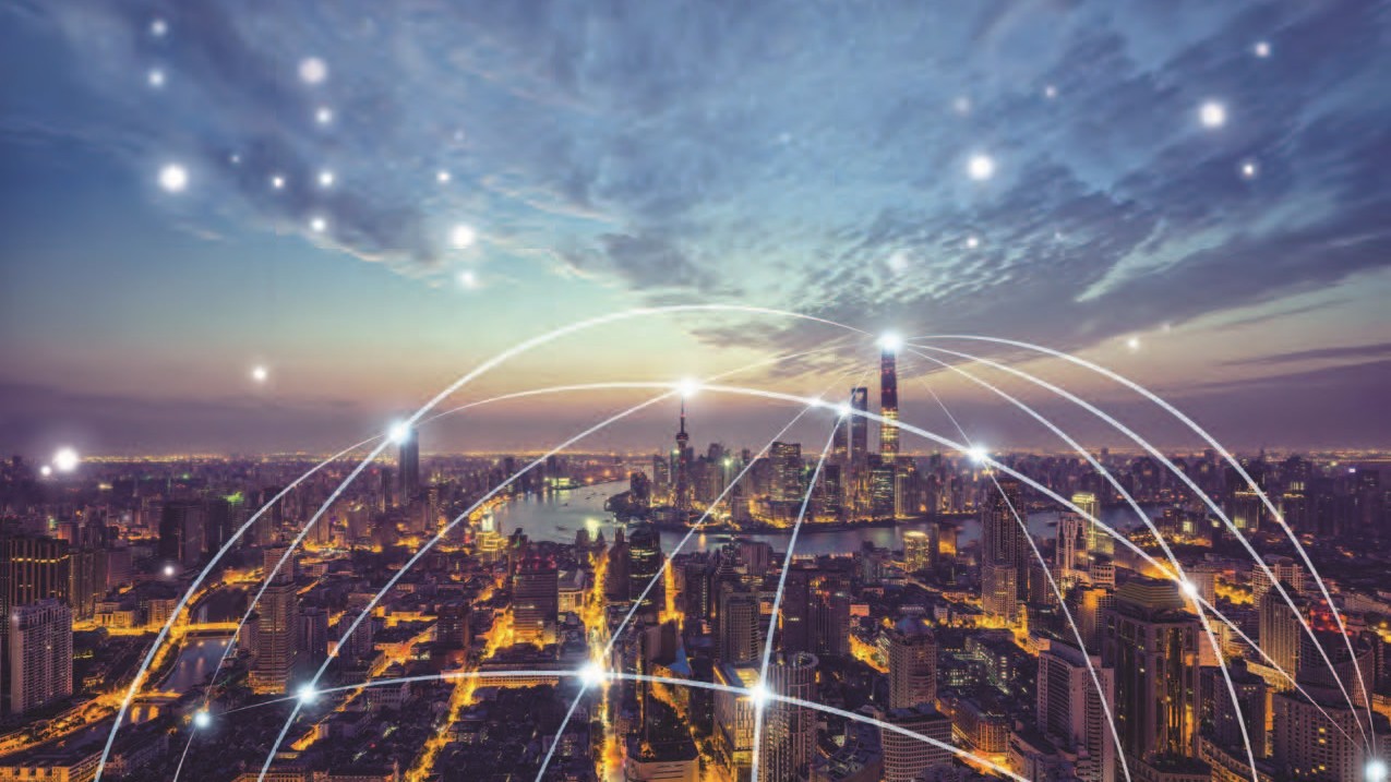 A city skyline at dusk with illuminated buildings. White light trails and glowing points are superimposed, representing digital connectivity and network communication across the urban landscape.